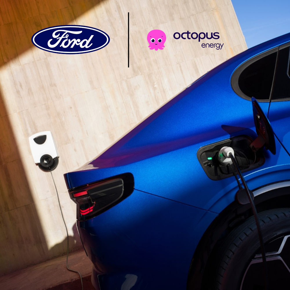 A  rear view of a blue Ford Capri eletric vehicle plugged in to an EV home charging point. 