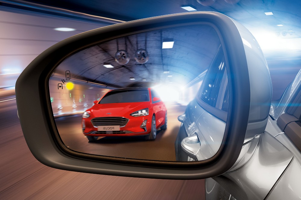 Ford Focus rouge dans un rétroviseur