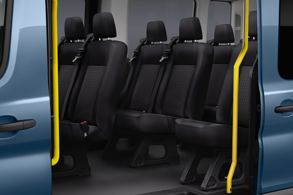 Vue des sièges passagers du Ford Transit Kombi à travers la porte latérale coulissante.